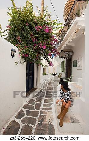 Woman posing in the alleys of town center, Mykonos, Cyclades Islands, Greek Islands, Greece, Europe. View Large Photo Image Stock Image - Woman posing in the alleys of town center, Mykonos, Cyclades Islands, Greek Islands, Greece, Europe.. Fotosearch