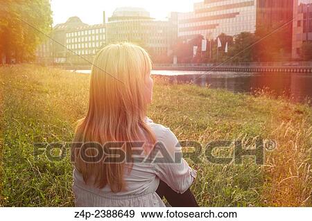 woman sitting near a river spree in berlin germany View Large Photo Image Stock Photo - woman sitting near a river spree in berlin germany. Fotosearch