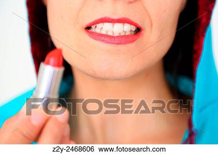 Stock Photograph - Woman with red lips showing the lipstick.. Fotosearch