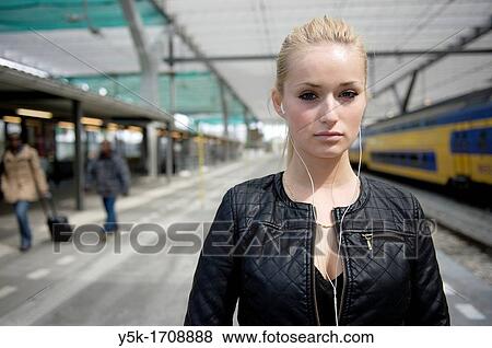 Young, blonde female, on the platform of a railway-station, waiting for her train. View Large Photo Image Stock Photo - Young, blonde female, on the platform of a railway-station, waiting for her train.. Fotosearch