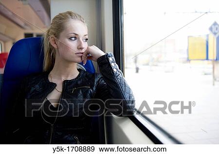 Young, blonde woman, traveling by train from Rotterdam to Nieuwerkerk. View Large Photo Image Stock Photo - Young, blonde woman, traveling by train from Rotterdam to Nieuwerkerk.. Fotosearch