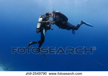 Young couple divers kissing underwater, Indian Ocean, Maldives. View Large Photo Image Stock Image - Young couple divers kissing underwater, Indian Ocean, Maldives.. Fotosearch