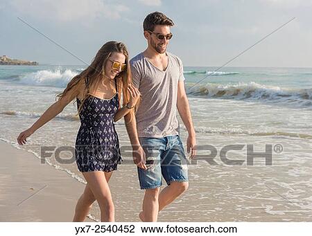Young couple outdoors. View Large Photo Image Stock Image - Young couple outdoors.. Fotosearch