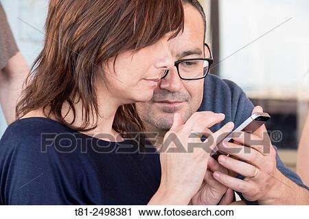 Young couple with mobile phone, Valencia, Spain View Large Photo Image Stock Image - Young couple with mobile phone, Valencia, Spain. Fotosearch
