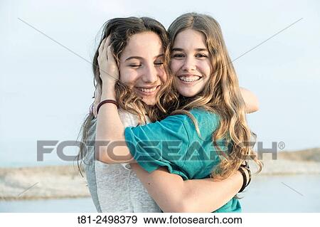 Young girls hugging on the beach, Valencia, Spain View Large Photo Image Stock Photo - Young girls hugging on the beach, Valencia, Spain. Fotosearch