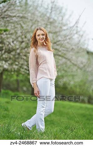 Young woman between flowering apple trees in spring. View Large Photo Image Stock Photo - Young woman between flowering apple trees in spring.. Fotosearch