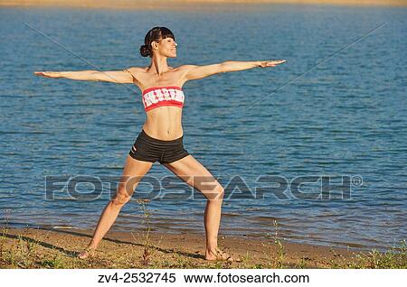 Young woman doing yoga on a beach next to a little lake. View Large Photo Image Stock Photography - Young woman doing yoga on a beach next to a little lake.. Fotosearch
