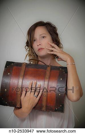 Young woman holding a wooden case. View Large Photo Image Stock Photo - Young woman holding a wooden case.. Fotosearch