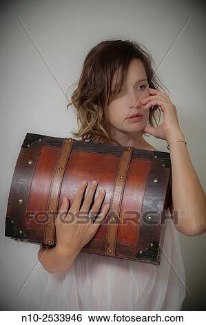 Young woman holding a wooden case. View Large Photo Image Stock Photograph - Young woman holding a wooden case.. Fotosearch