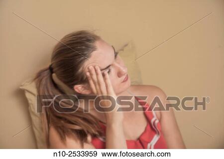 Stock Photo - Young woman thinking.. Fotosearch