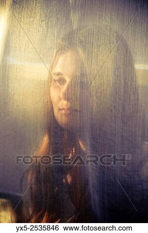 Stock Photograph - young woman with face obscured by a cloth.. Fotosearch