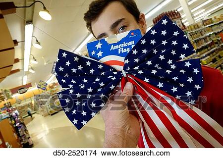 14 yr old boy with American flag, or bunting, in supermarket, Sharon, Connecticut, USA View Large Photo Image Picture - 14 yr old boy with American flag, or bunting, in supermarket, Sharon, Connecticut, USA. Fotosearch