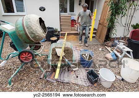 A builder with tools and materials working in a house in the Uk. View Large Photo Image Picture - A builder with tools and materials working in a house in the Uk.. Fotosearch