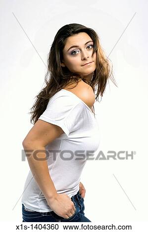 A long haired, pretty girl dressed in a tight fitting, bare shoulder, white top is seen from the side, and she turns toward the camera her hands in her blue jeans pockets and her head tilted back. View Large Photo Image Stock Image - A long haired, pretty girl dressed in a tight fitting, bare shoulder, white top is seen from the side, and she turns toward the camera her hands in her blue jeans pockets and her head tilted back.. Fotosearch