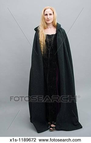 An attractive American woman with beautiful long, flowing blond hair in a medieval era dress and long, flowing cape. View Large Photo Image Stock Image - An attractive American woman with beautiful long, flowing blond hair in a medieval era dress and long, flowing cape.. Fotosearch