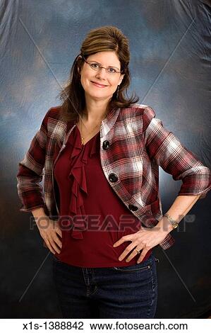 Stock Image - An attractive woman in jeans and a blue shirt. Fotosearch