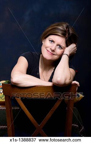 An attractive woman in jeans and a blue shirt View Large Photo Image Stock Photo - An attractive woman in jeans and a blue shirt. Fotosearch