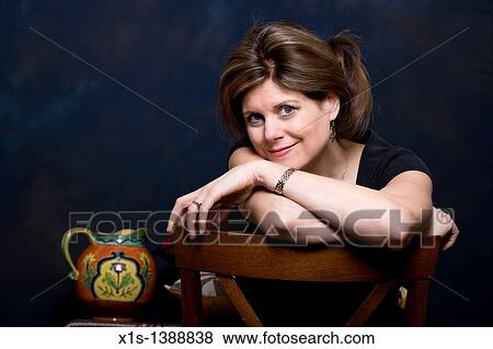 An attractive woman in jeans and a blue shirt View Large Photo Image Stock Photo - An attractive woman in jeans and a blue shirt. Fotosearch