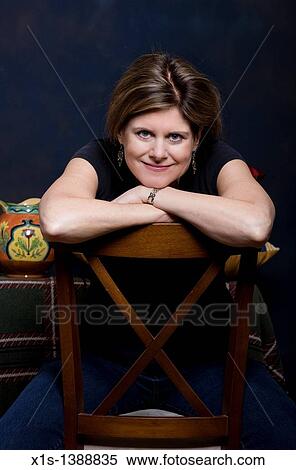 An attractive woman in jeans and a blue shirt View Large Photo Image Stock Photography - An attractive woman in jeans and a blue shirt. Fotosearch