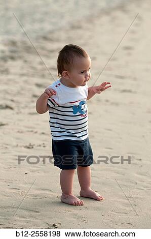 Baby on the beach - First steps on the sand. View Large Photo Image Stock Photo - Baby on the beach - First steps on the sand.. Fotosearch