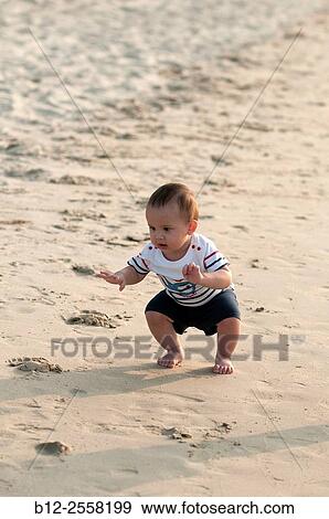Baby on the beach - First steps on the sand. View Large Photo Image Stock Photo - Baby on the beach - First steps on the sand.. Fotosearch