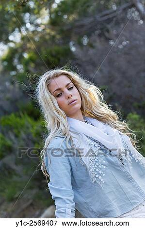 Stock Photo - Beautiful blonde countrygirl n denim shirt waist-up shot.. Fotosearch