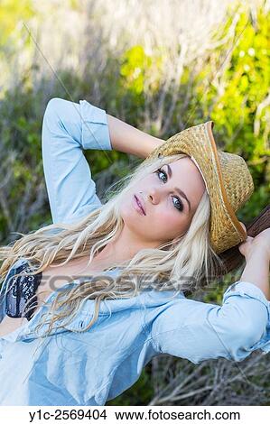Picture - Beautiful blonde countrygirl portrait with stetson hat. Fotosearch