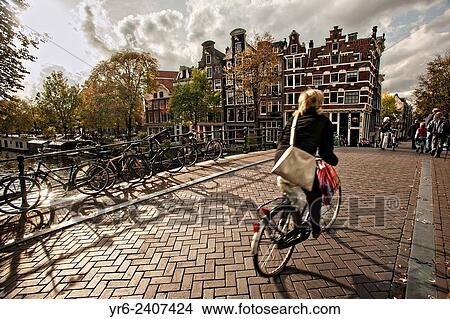 Bicyclist crossing the the Hemonybrug bridge at Keizersgracht and Leidsegracht in Amsterdam. View Large Photo Image Picture - Bicyclist crossing the the Hemonybrug bridge at Keizersgracht and Leidsegracht in Amsterdam.. Fotosearch