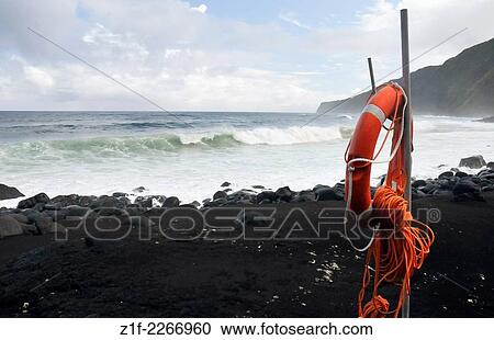 Stock Image - Black sand beach on Faial island, Azores, Portugal.. Fotosearch