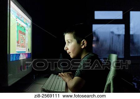 Boy, 7 playing computer games at home. View Large Photo Image Stock Image - Boy, 7 playing computer games at home.. Fotosearch