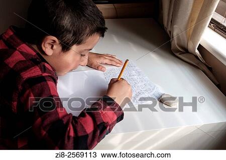 Boy 7, writes essay at home. View Large Photo Image Stock Image - Boy 7, writes essay at home.. Fotosearch