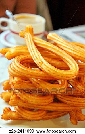 Stock Photo - Breakfast table churros and coffee Spain. Fotosearch