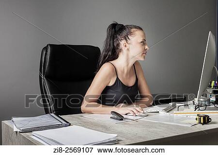 Stock Photo - Businesswoman on her desk.. Fotosearch