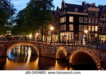 Stock Image - Canal at dusk in Amsterdam, Holland.. Fotosearch