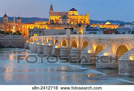 Cathedral (Mezquita) and Roman bridge at sunset, Guadalquivir river, Cordoba, Andalusia, Spain. View Large Photo Image Stock Photo - Cathedral (Mezquita) and Roman bridge at sunset, Guadalquivir river, Cordoba, Andalusia, Spain.. Fotosearch