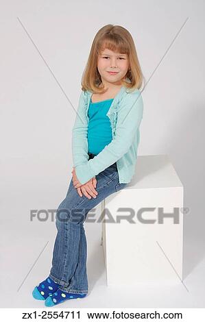 Child portrait of a blond haired girl on a white sweep wearing a green a green cami set in jean sitting on a white wood block. View Large Photo Image Stock Image - Child portrait of a blond haired girl on a white sweep wearing a green a green cami set in jean sitting on a white wood block.. Fotosearch
