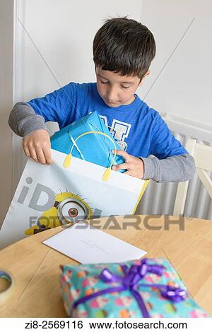 Stock Photograph - Child prepares presents.. Fotosearch