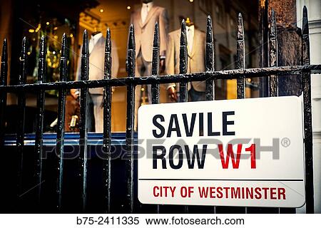 Closeup of a sign of Savile Row Street W1, hung on a Street fence, City of Westminster, with tailoring business in the background. London, England, UK, Europe. View Large Photo Image Stock Photography - Closeup of a sign of Savile Row Street W1, hung on a Street fence, City of Westminster, with tailoring business in the background. London, England, UK, Europe.. Fotosearch
