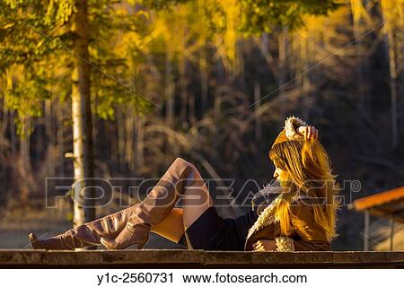 Stock Image - Country-girl in short dress and high boots. Fotosearch