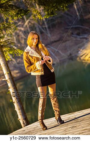 Stock Photo - Country-girl in short dress and high boots. Fotosearch