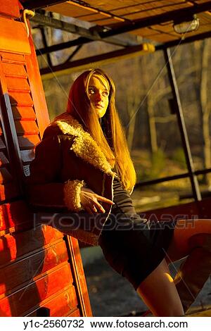 Country-girl watching sunset near wooden cabin View Large Photo Image Stock Image - Country-girl watching sunset near wooden cabin. Fotosearch