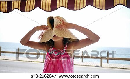 Cute Girl pulling her hat Down View Large Photo Image Stock Photo - Cute Girl pulling her hat Down. Fotosearch