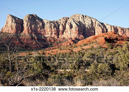 Desert sage brush and sandstone cliffs in Monument Valley. View Large Photo Image Stock Photo - Desert sage brush and sandstone cliffs in Monument Valley.. Fotosearch