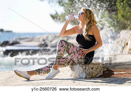Drinking bottled fresh water young blonde woman View Large Photo Image Stock Photograph - Drinking bottled fresh water young blonde woman. Fotosearch