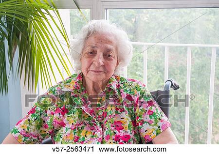 Elderly woman in a nursing home, smiling and looking at the camera. View Large Photo Image Stock Image - Elderly woman in a nursing home, smiling and looking at the camera.. Fotosearch