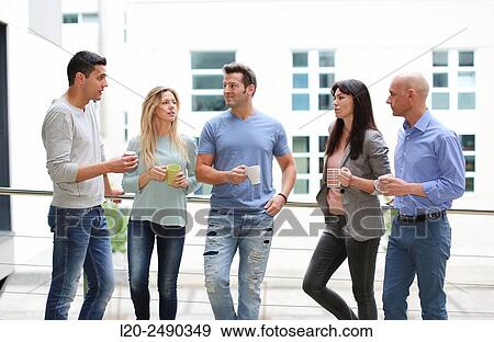Stock Photo - Executives drinking coffee. Break.. Fotosearch