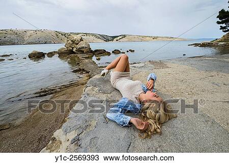 Fanciful young woman lying on back on in short dress and high-heels. View Large Photo Image Stock Image - Fanciful young woman lying on back on in short dress and high-heels.. Fotosearch