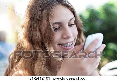 girl, mobil phone looking agenda, the garden, Calpe, Spain View Large Photo Image Stock Image - girl, mobil phone looking agenda, the garden, Calpe, Spain. Fotosearch