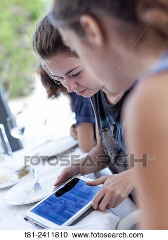 girls looking at a tablet in Benidorm, Spain View Large Photo Image Stock Image - girls looking at a tablet in Benidorm, Spain. Fotosearch