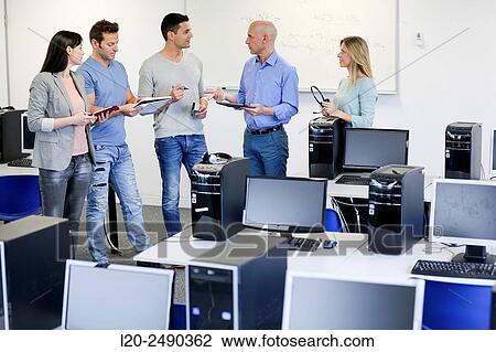 Stock Image - Group of teachers. Computer Academy.. Fotosearch